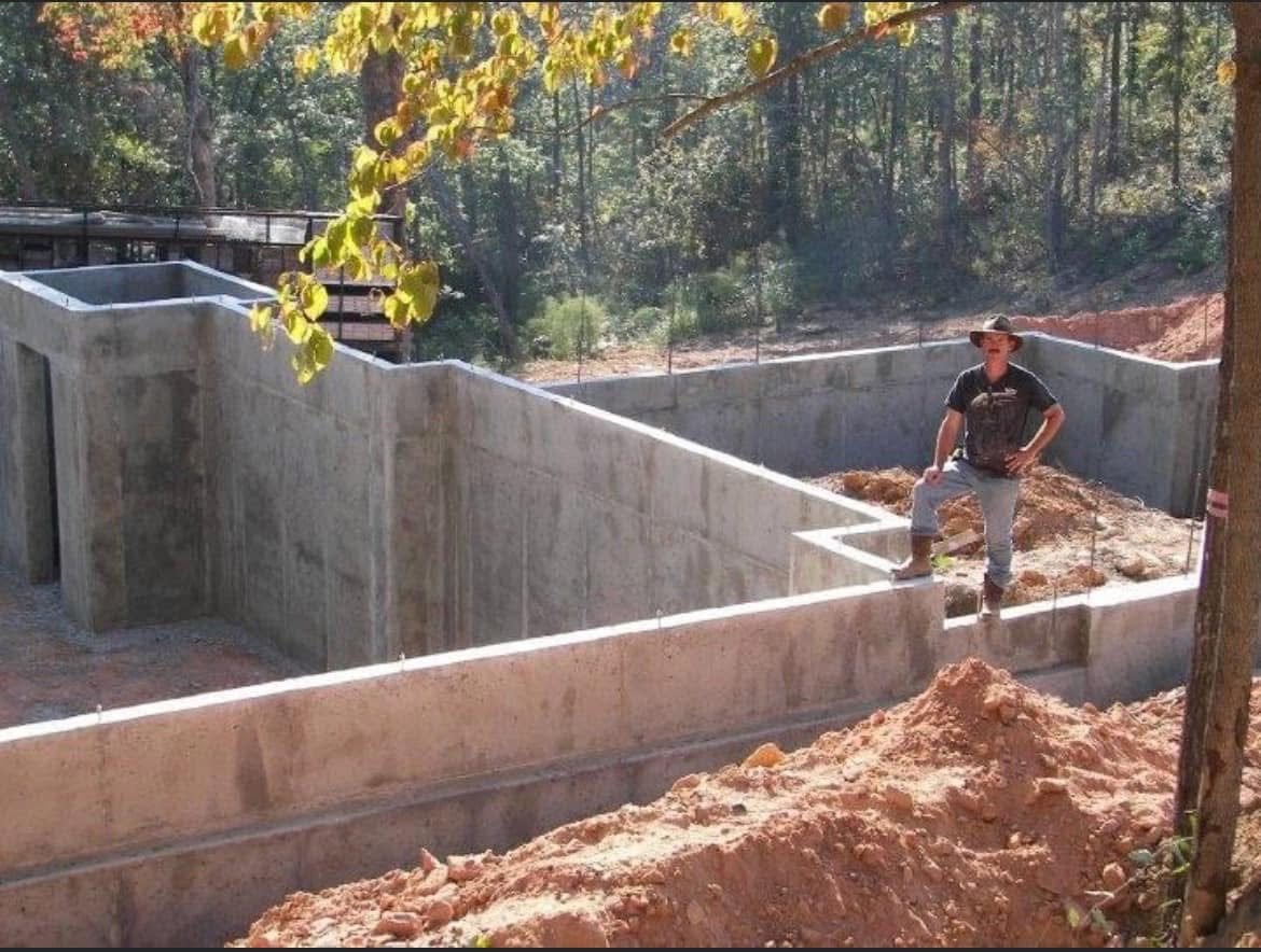 Owner surveying completed complex poured foundation