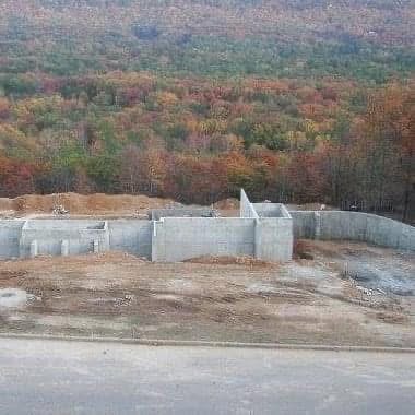 Large foundation pour against fall mountain foliage
