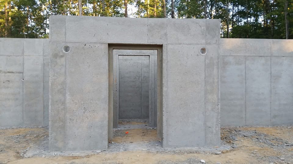 Poured concrete foundation with door and window openings